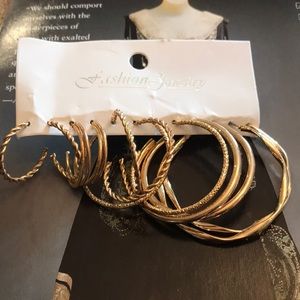 Set of 6 Gold tone pierced hoop earrings. New on card.